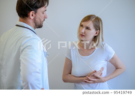 Adult woman discussing her health problems with a doctor 95419749