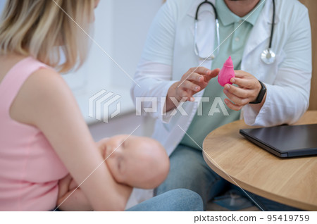 Female parent getting a professional consultation from a pediatrician 95419759