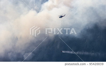 Wildfire Service Helicopter flying over BC Forest Fire and Smoke on the mountain near Hope Wildfire Service Helicopter flying over BC Forest Fire and Smoke on the mountain near Hope 95420039