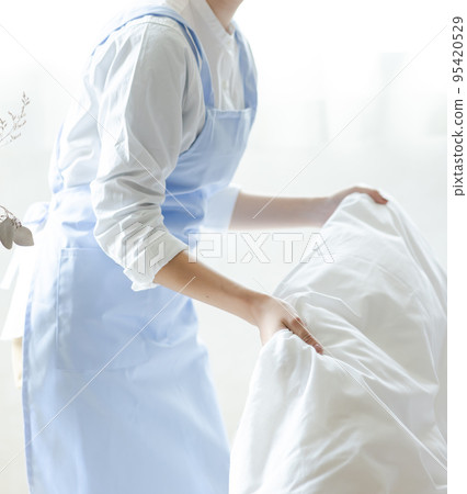 Cute woman making a bed 95420529