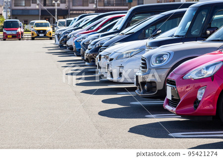 Passenger cars lining up in the parking lot 95421274