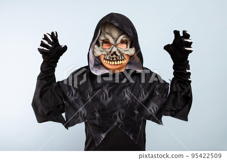 Portrait of angry little boy in halloween costume with frightening gesture Portrait of angry little boy in halloween costume with frightening gesture 95422509