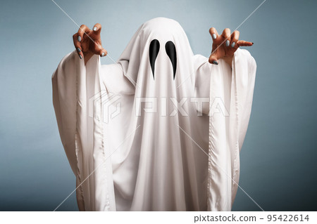 Halloween Concept. A white ghost with black eyes, made from a bedsheet 95422614