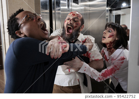 Dangerous creepy zombies attacking afraid man, leaving elevator and hunting person to eat brain. Scared adult running from horror terrifying evil monsters, walking dead sinister corpses. 95422752