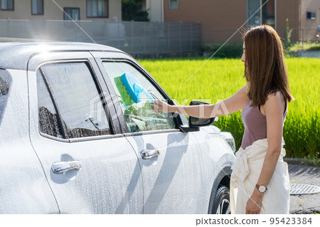A woman washing a car car wash A woman washing a car car wash 95423384