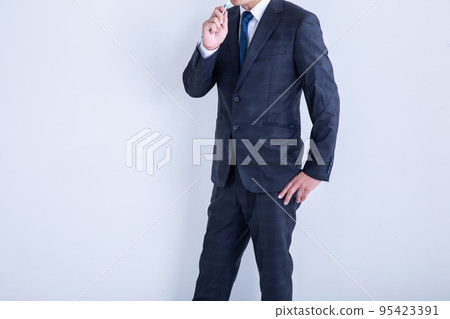 A man smoking in a suit smoking A man smoking in a suit smoking 95423391