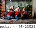 Huge family siiting on floor. Christmas time. 95423523