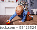 Small caucasian boy playing with fire truck.  95423524
