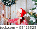 Woman in santa hat talking video call. 95423525