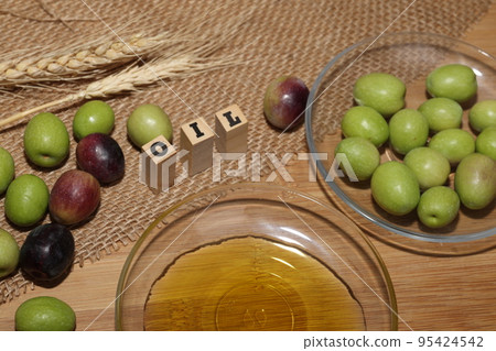 Olives and Olive Oil on wooden background 95424542