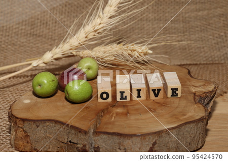 Olives and Olive Oil on wooden background Olives and Olive Oil on wooden background 95424570