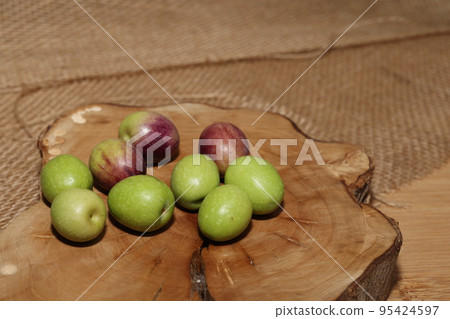 Olives and Olive Oil on wooden background Olives and Olive Oil on wooden background 95424597