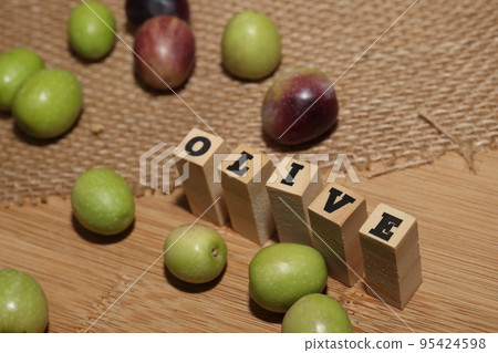 Olives and Olive Oil on wooden background Olives and Olive Oil on wooden background 95424598