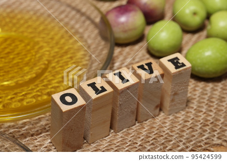 Olives and Olive Oil on wooden background 95424599