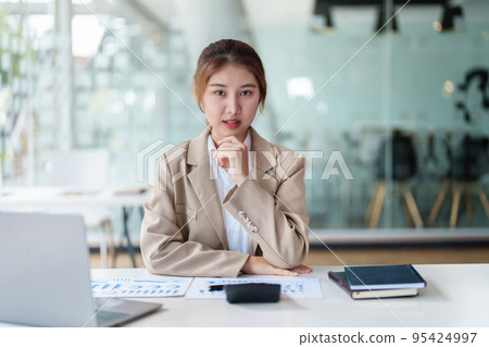 data analysis, plan, marketing, accounting, audit, Portrait of asian business woman planning marketing using statistical data sheet and computer to present marketing plan project at meeting 95424997