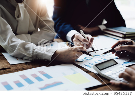 financial, Brainstorming, Consulting, Data Analysis, Planning, Marketing and Accounting, Economists pen pointing to investment documents with partners on profit taking to compete with other companies financial, Brainstorming, Consulting, Data Analysis, Planning, Marketing and Accounting, Economists pen pointing to investment documents with partners on profit taking to compete with other companies 95425157