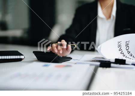accountant, Auditor, Self-Employed, Finance and Investment, tax calculation and budget, Asian female entrepreneur using a calculator to calculate. Company business results document accountant, Auditor, Self-Employed, Finance and Investment, tax calculation and budget, Asian female entrepreneur using a calculator to calculate. Company business results document 95425184