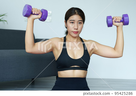stress relief, , breathing exercises, meditation, portrait of Asian healthy woman lifting weights to strengthen her muscles after work 95425286