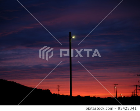 Sunset sky and electric lights at the end of summer 95425341