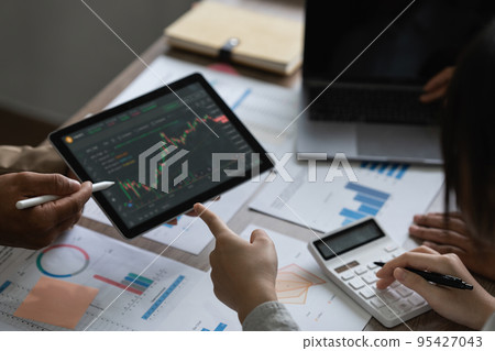 Fund managers team consultation and discuss about analysis Investment stock market by digital tablet Fund managers team consultation and discuss about analysis Investment stock market by digital tablet 95427043