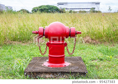 Red fire hydrants on the roadside in the community area are used to extinguish fires in the event of a fire. Red fire hydrants on the roadside in the community area are used to extinguish fires in the event of a fire. 95427383