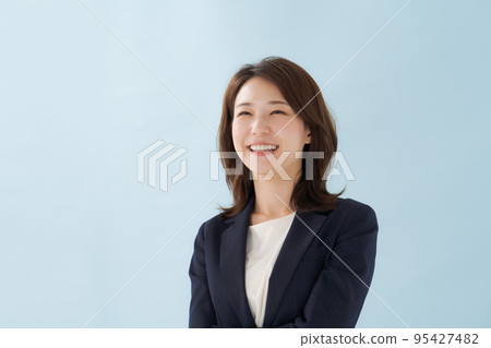 A woman in a suit blue background A woman in a suit blue background 95427482