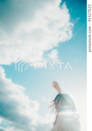 Photo of a woman standing by the beach 95427625