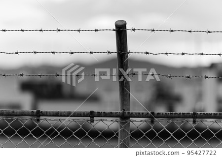 barbed wire on iron fence barbed wire on iron fence 95427722