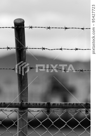 barbed wire on iron fence barbed wire on iron fence 95427723