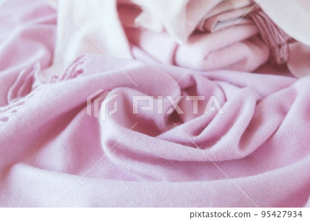 Cashmere texture, natural wool, pink cashmere scarf folded, top view, concept of warmth and winter comfort Cashmere texture, natural wool, pink cashmere scarf folded, top view, concept of warmth and winter comfort 95427934