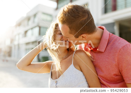 Lovely happy couple.Hugs together and smile in sunset light Lovely happy couple.Hugs together and smile in sunset light 95429053