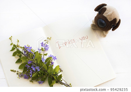 i miss you message handwriting on notebook with dog toy purple flowers i miss you message handwriting on notebook with dog toy purple flowers 95429235
