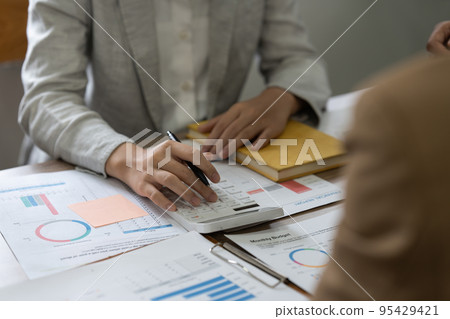 Group of business asian people analysis financial graph on desk at meeting room Group of business asian people analysis financial graph on desk at meeting room 95429421