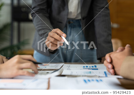Group of business asian people analysis financial graph on desk at meeting room Group of business asian people analysis financial graph on desk at meeting room 95429423