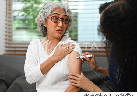 Senior female diabetes taking insulin from nurse. Diabetes and elderly healthcare concept Senior female diabetes taking insulin from nurse. Diabetes and elderly healthcare concept 95429903