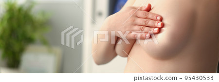 Woman cover breasts with hands, natural female breasts, willing to enlarge boobs 95430533