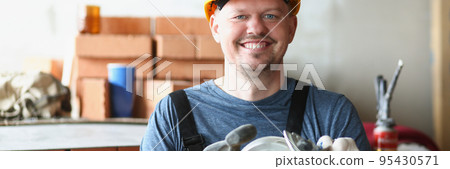 Happy carpenter worker with professional sander machine get ready to work 95430571