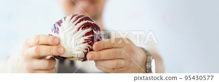 Male blogger with organic and purple vegetable in kitchen, healthy vegetarian food blog 95430577