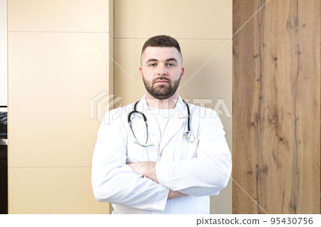 Portrait of young doctor man with medical instruments, smiling, looking at camera Portrait of young doctor man with medical instruments, smiling, looking at camera 95430756