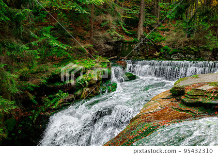 Nature landscape. Waterfall. Beautiful fall mountain wild Forest waterfall with green moss cover stones. Forest autumn landscape. Scenery of nature Nature landscape. Waterfall. Beautiful fall mountain wild Forest waterfall with green moss cover stones. Forest autumn landscape. Scenery of nature 95432310