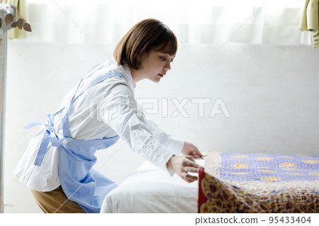 Cute woman making a bed 95433404