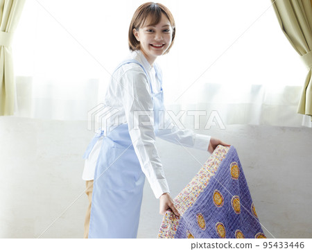 Cute woman making a bed 95433446