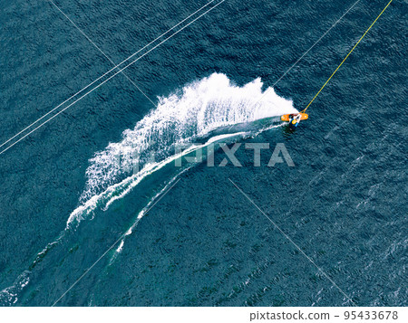 Top view of a wakeboard rider in wake cable park Top view of a wakeboard rider in wake cable park 95433678