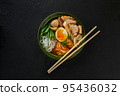 Traditional Japanese soup with meat broth, asian rice noodles, sliced chiken, eggs. Close up. Asian style food. Top view. Hot tasty ramen soup for dinner. 95436032