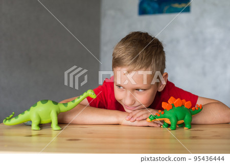 A child plays with animal figures A child plays with animal figures 95436444