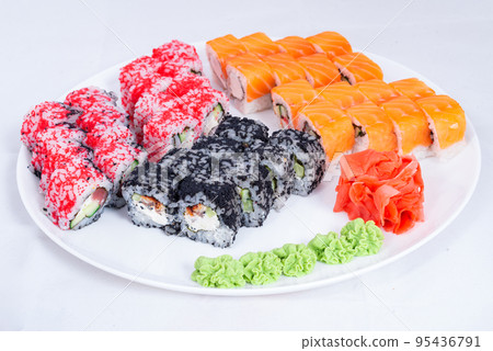 Japanese seafood Sushi roll isolated on white close up. Japanese food restaurant, sushi maki gunkan roll plate or platter set. Maki Sushi rolls with salmon and avocado. Sushi isolated at white 95436791