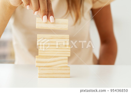 Woman hand stacked wooden blocks with space for text Woman hand stacked wooden blocks with space for text 95436850