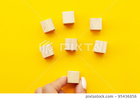 Close up woman's hand stacked wooden blocks with space for text Close up woman's hand stacked wooden blocks with space for text 95436856
