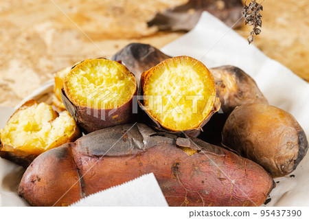 Baked potato with harvested potatoes 95437390