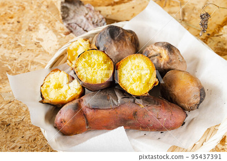 Baked potato with harvested potatoes 95437391